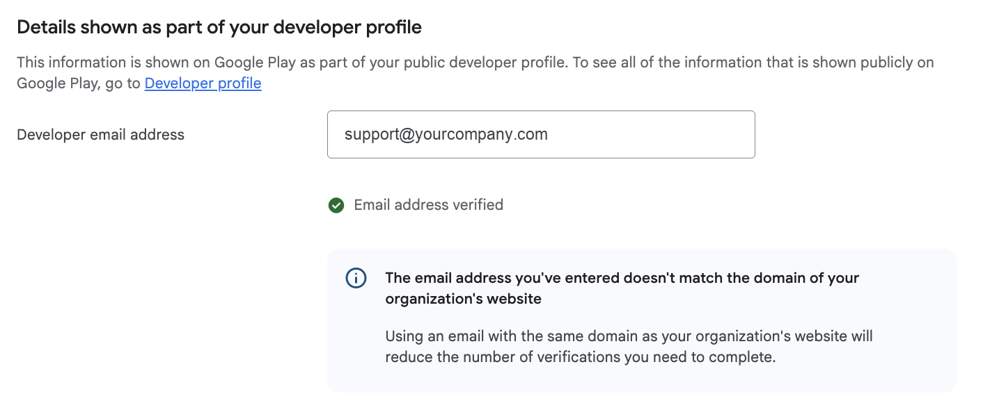 Google Play Console showing Email address verified with a green tick while the domain mismatch notice is still displayed
